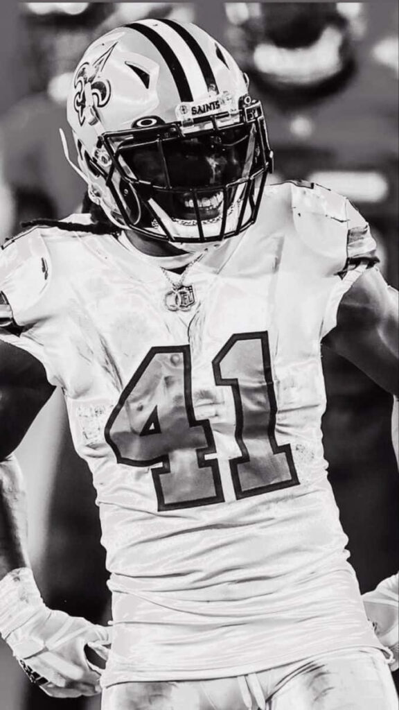 Alvin Kamara Saints black and white wallpaper dynamic pose intense football focus background