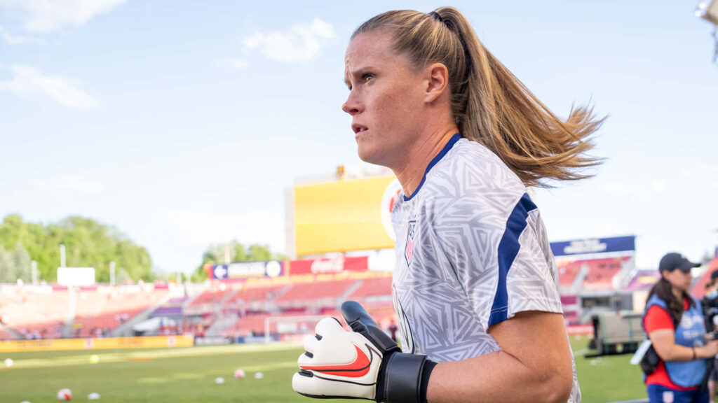 Alyssa Naeher focused goalkeeper in training jersey and gloves during soccer match warm-up Wallpaper