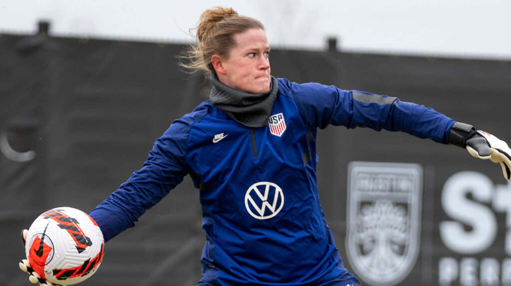 Alyssa Naeher goalkeeper focused preparing powerful throw defending goal dynamic soccer wallpaper