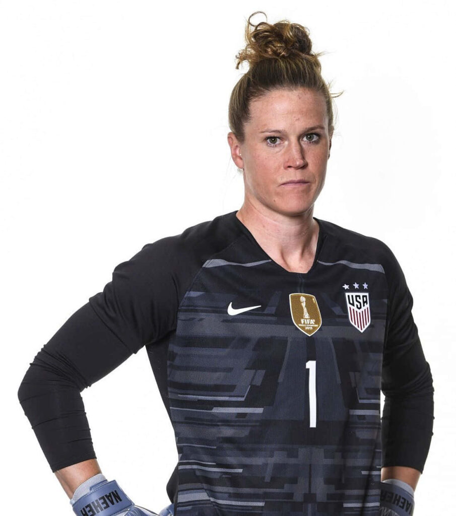 Alyssa Naeher in USA soccer goalkeeper kit showing focus and determination on dynamic wallpaper