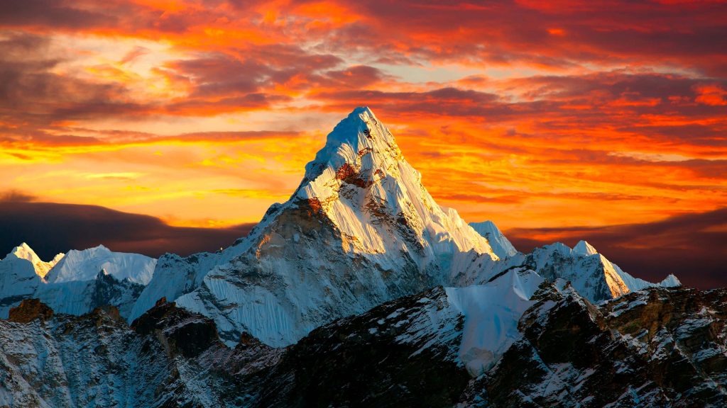 Ama Dablam peak in Himalayas glowing golden hour sunset with snowy mountain and fiery sky Wallpaper