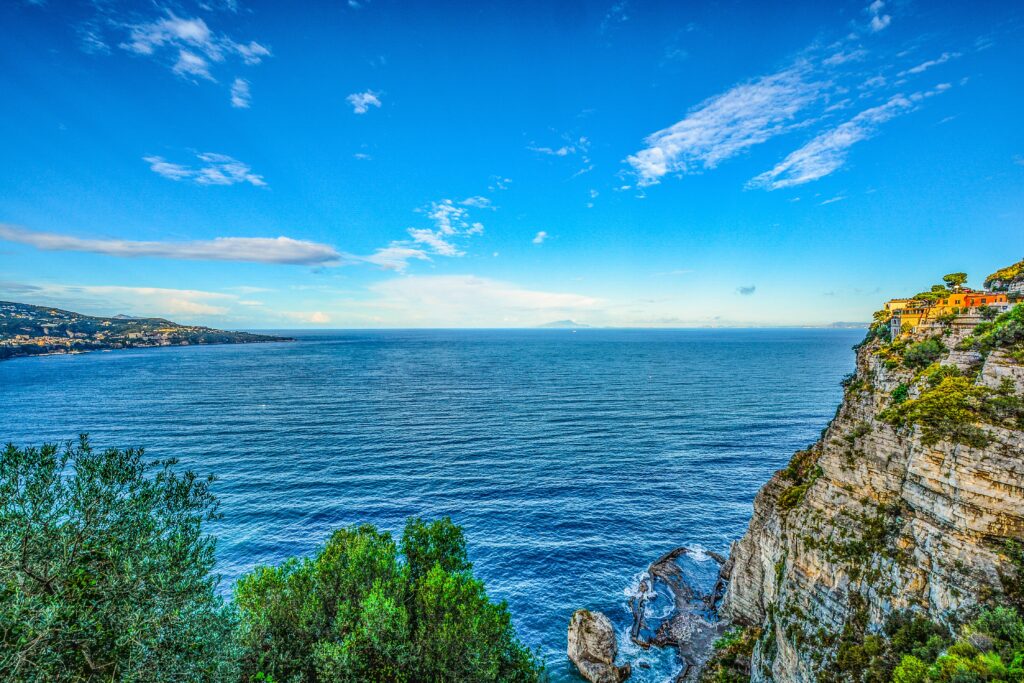 Amalfi Coastline wallpaper with lush hills cliffs deep blue sea and vibrant Mediterranean sky