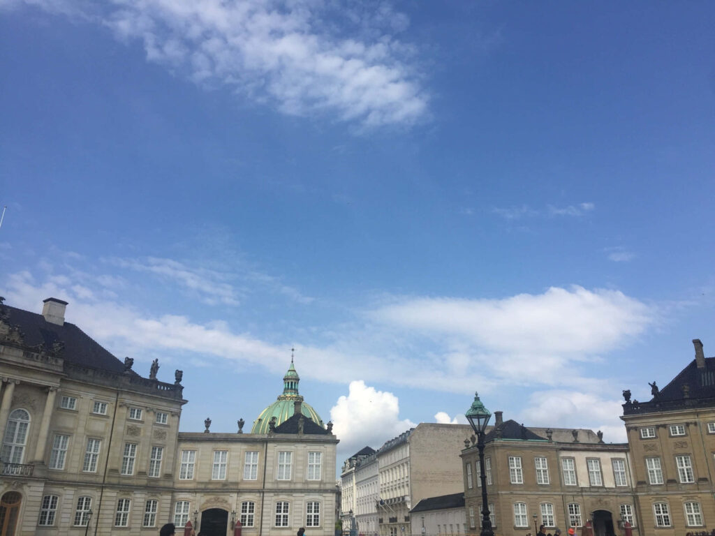 Amalienborg Palace historic architecture with vibrant blue sky wallpaper background view
