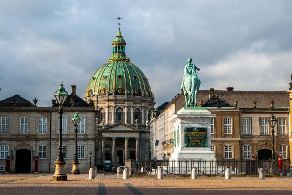 Amalienborg Palace with Equestrian Statue green dome historic buildings serene sky wallpaper background