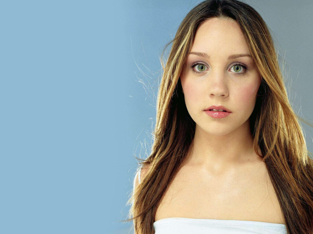 Amanda Bynes wide eyed expressive look soft blue background striking wallpaper image