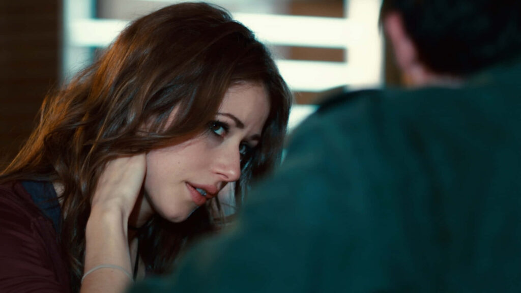 Amanda Crew in a thoughtful intense conversation showing deep emotion striking wallpaper background