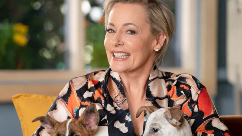 Amanda Keller smiling warmly holding two adorable dogs cheerful inviting wallpaper background