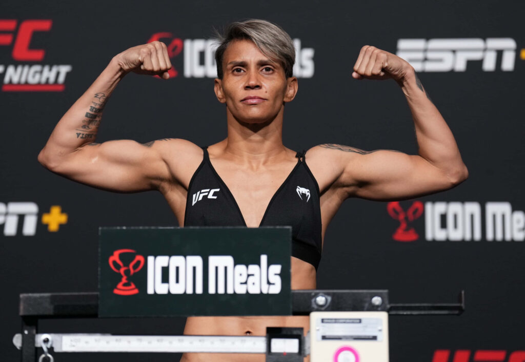 Amanda Lemos flexing muscles on weigh-in stage showing strength determination MMA fighter Wallpaper