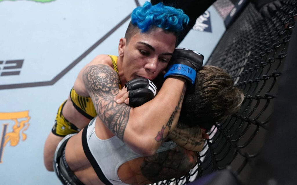 Amanda Lemos showing intense focus clinching opponent against cage in professional MMA fight wallpaper