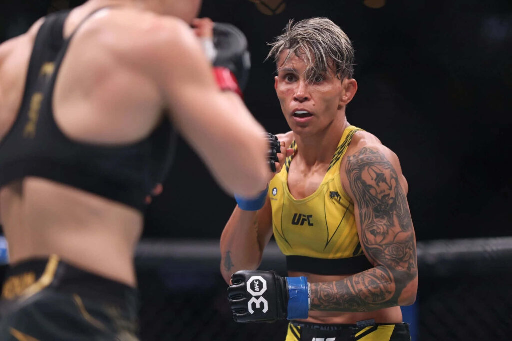 Amanda Lemos intense MMA fight moment showing focus athleticism and fighting spirit in octagon Wallpaper