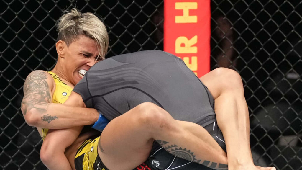 Amanda Lemos intense MMA grapple showing strength determination inside octagon wallpaper background