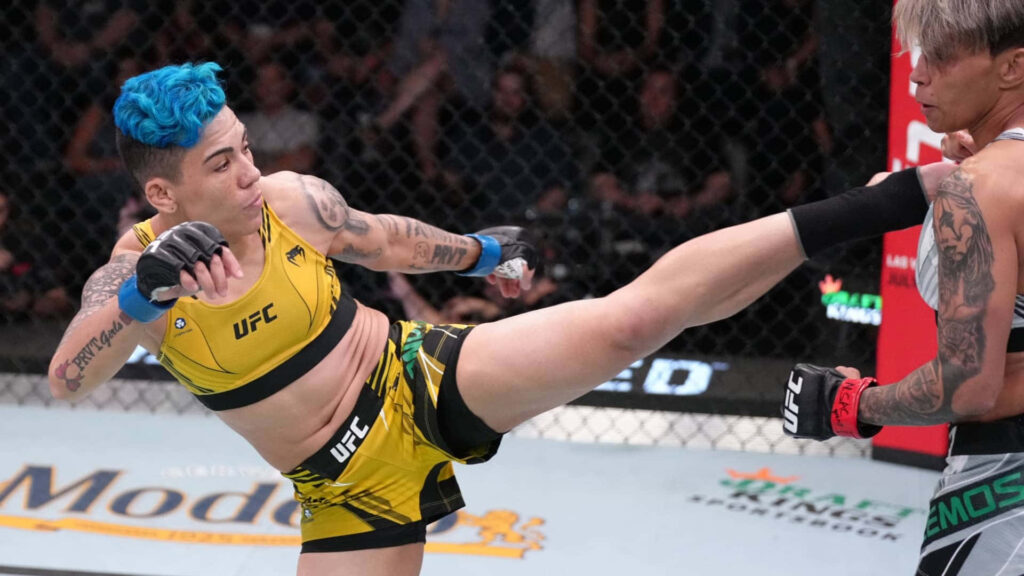 Amanda Lemos executing a powerful high kick in a UFC fight showcasing MMA intensity and skill Wallpaper