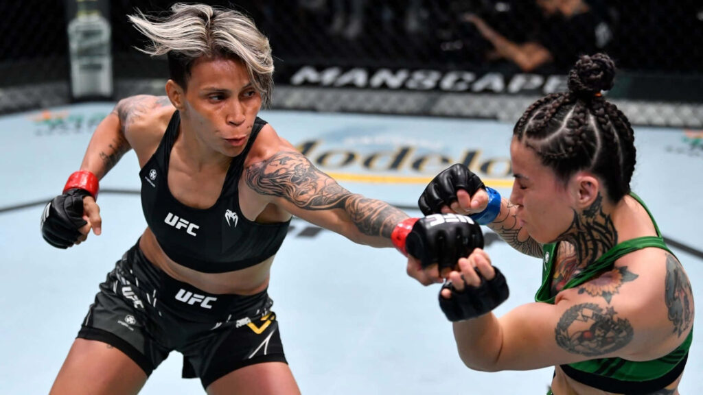 Amanda Lemos lands a powerful punch in intense UFC fight showcasing fierce fighter determination Wallpaper