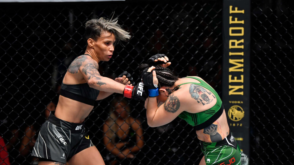 Amanda Lemos delivers a powerful punch in UFC octagon showing strength and MMA determination Wallpaper