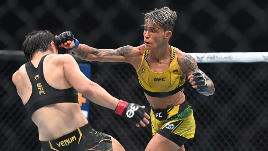 Amanda Lemos striking in UFC octagon during intense fight showcasing her fighting spirit wallpaper