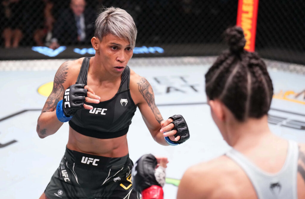 Amanda Lemos focused fighting stance inside UFC Octagon ready for match intense MMA action Wallpaper