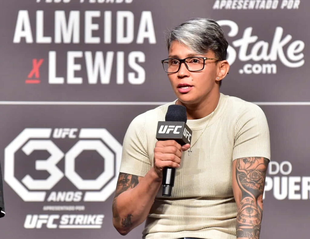 Amanda Lemos UFC press conference speaking holding microphone intense contender backdrop logos Wallpaper