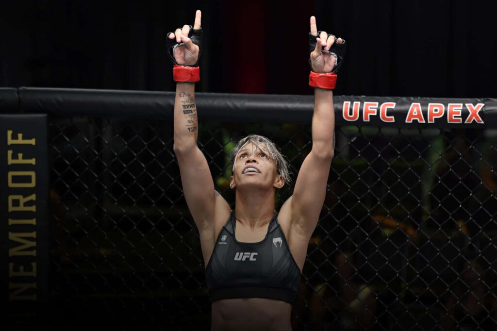 Amanda Lemos UFC victory celebration raising hands in octagon showing pride and determination Wallpaper