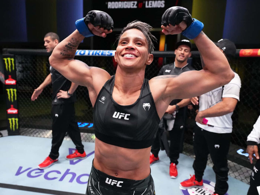 Amanda Lemos victorious UFC fighter celebrating strength determination in octagon wallpaper background