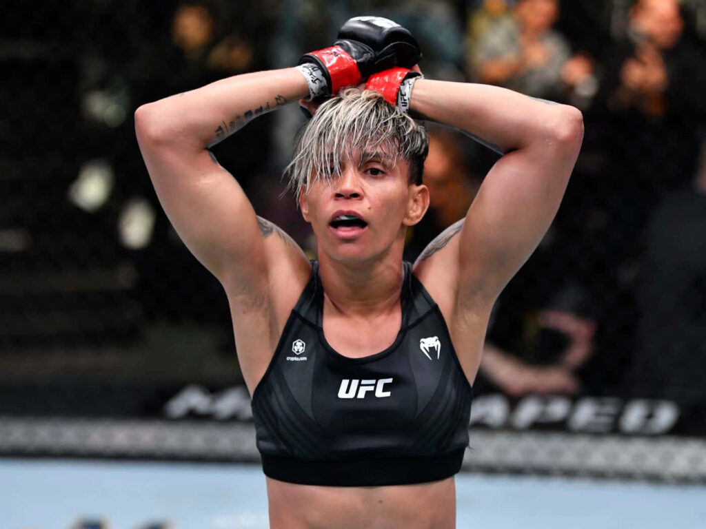 Amanda Lemos UFC fighter victorious pose raising hands in octagon showcasing strength and determination Wallpaper