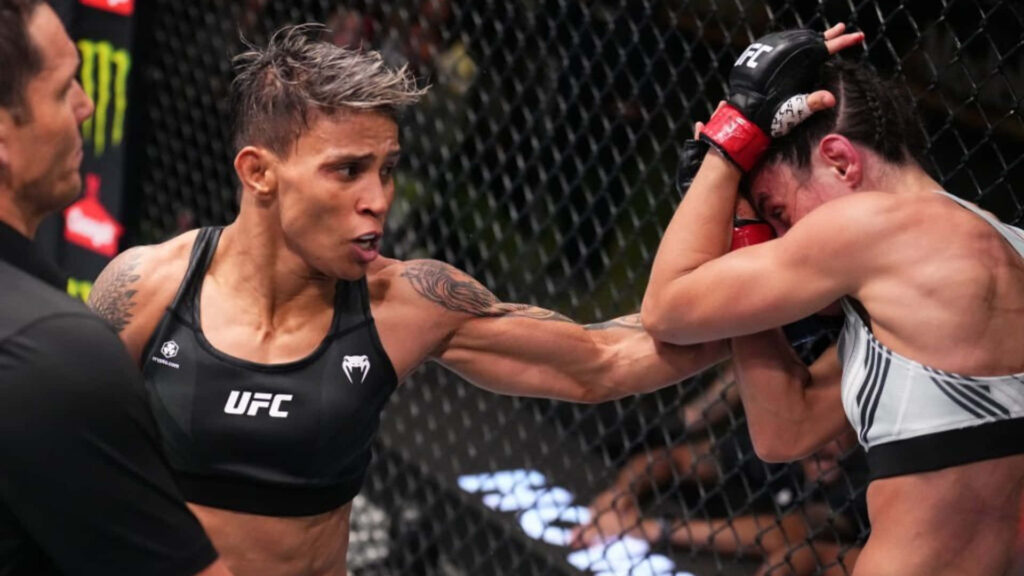 Amanda Lemos UFC fighter delivering powerful strike showing intense athleticism in octagon fight Wallpaper