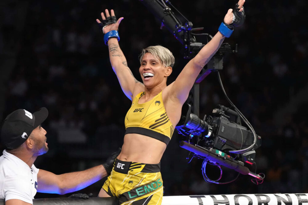 Amanda Lemos MMA fighter celebrating victory inside octagon with dynamic energetic pose wallpaper