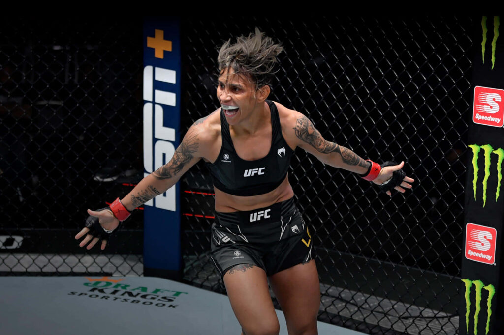 Amanda Lemos celebrates victory inside UFC octagon showing athleticism and excitement wallpaper