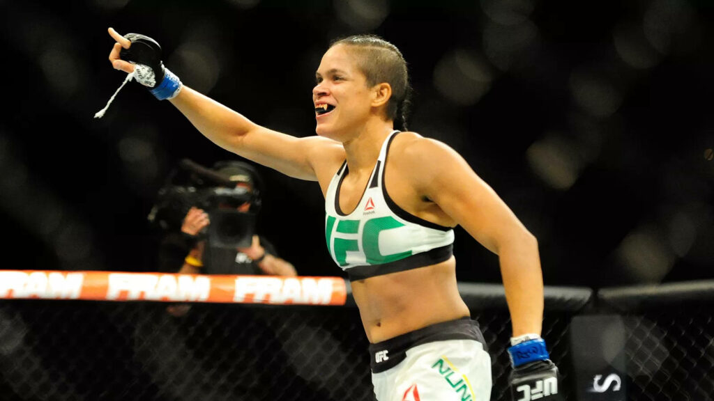 Amanda Nunes celebrating confidently with a big smile and pointing in UFC octagon fight wallpaper