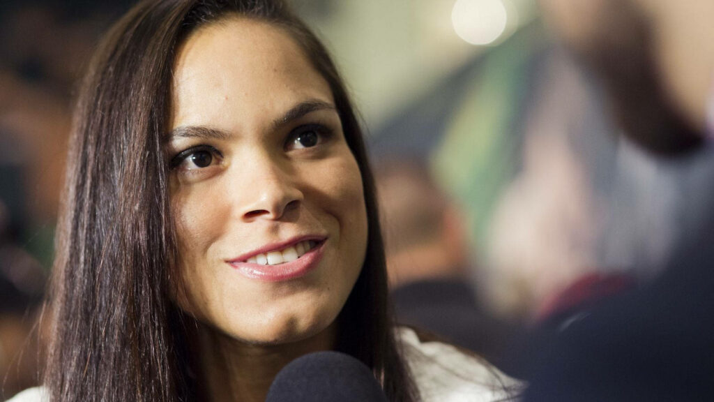 Amanda Nunes confident smile interview microphone blurred background focused expression wallpaper