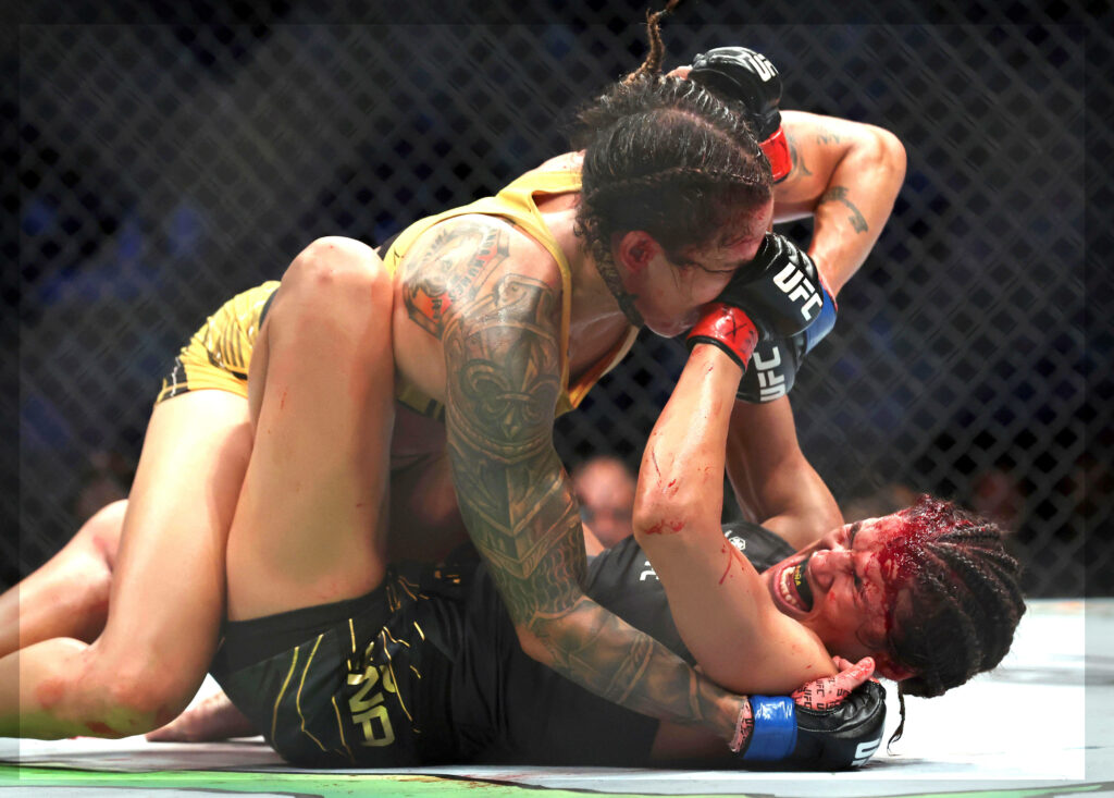 Amanda Nunes dominating Julianna Peña with powerful ground control in intense UFC octagon fight wallpaper