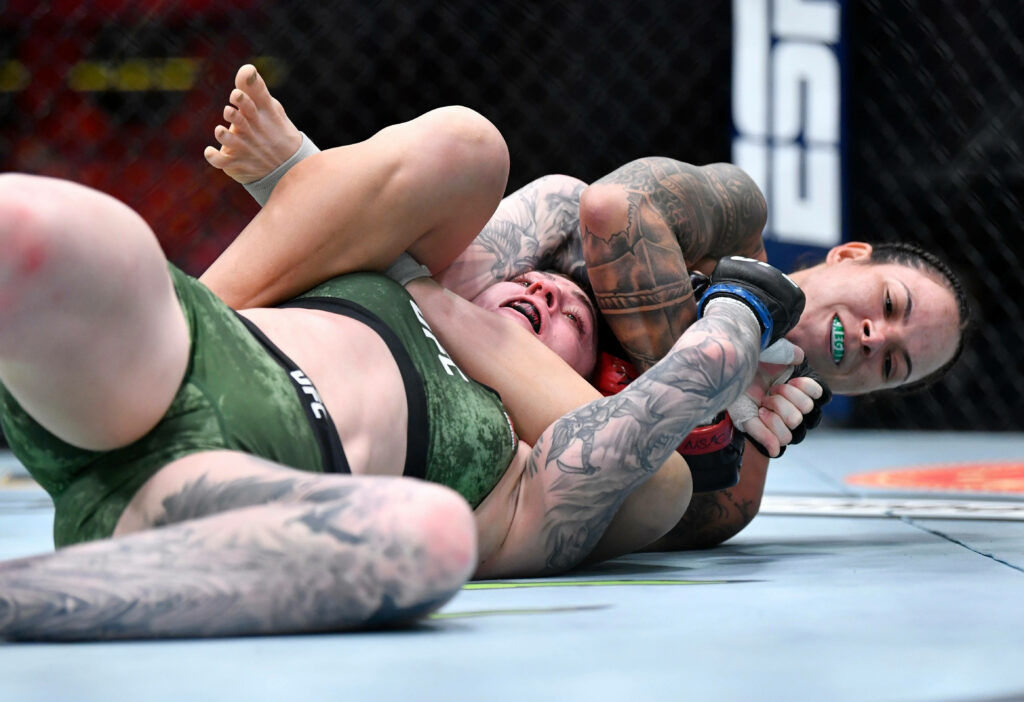 Amanda Nunes grappling and controlling opponent in intense UFC fight octagon wallpaper background