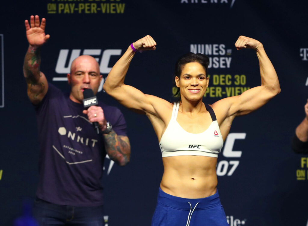 Amanda Nunes flexing muscles during UFC weigh-in showing strength confidence champion Wallpaper