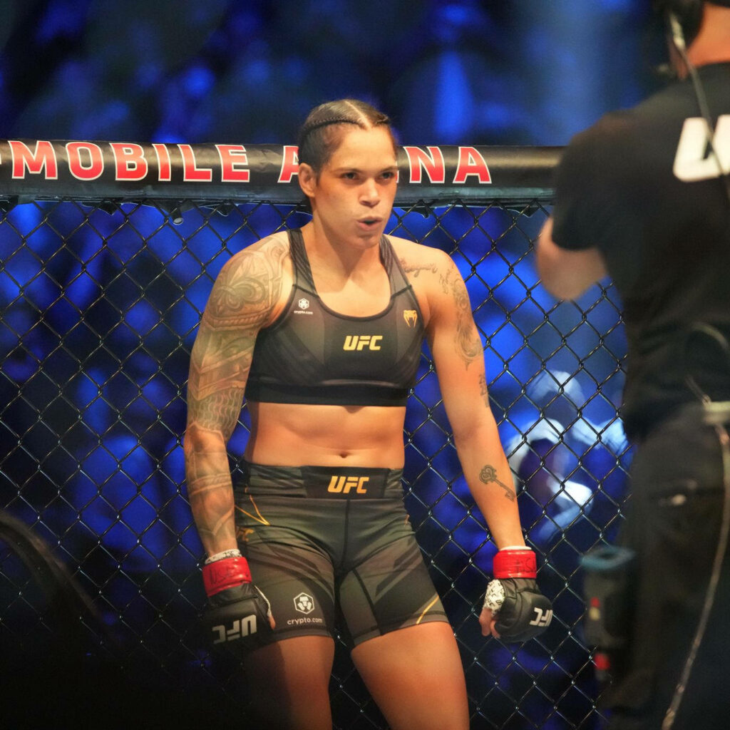 Amanda Nunes focused inside UFC Octagon exhaling with strength and determination wallpaper