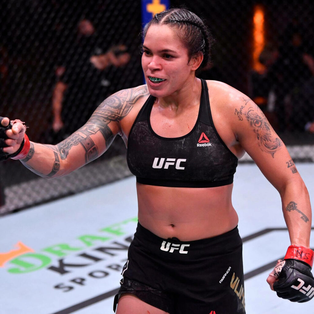 Amanda Nunes stands confidently in UFC octagon showing strength determination after fierce match wallpaper
