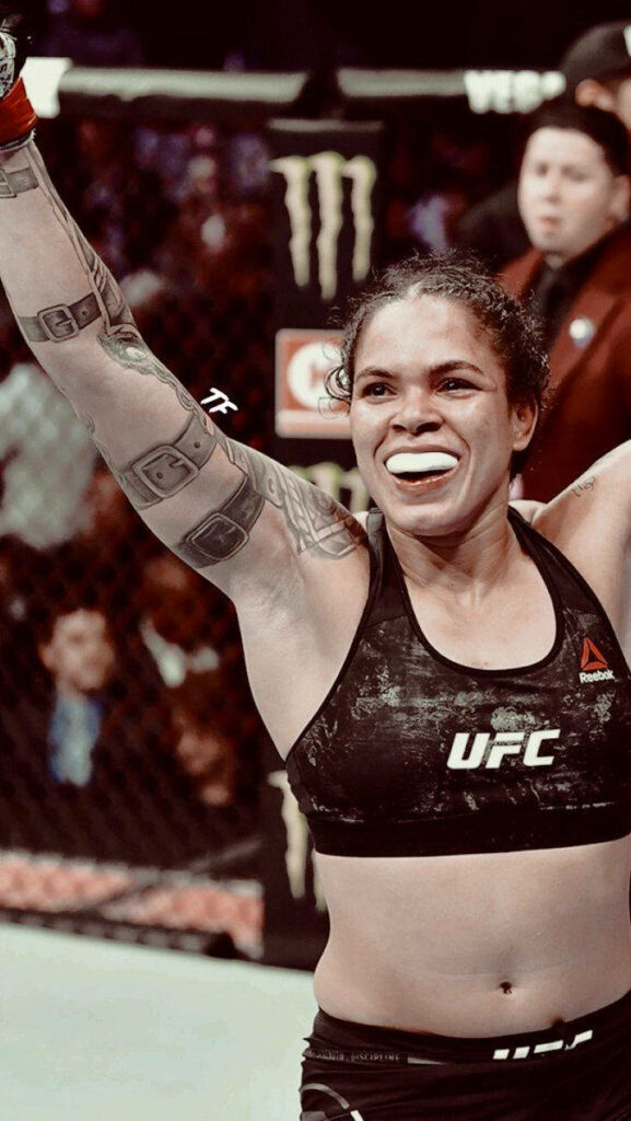 Amanda Nunes celebrates UFC victory inside octagon showing confidence and determination wallpaper