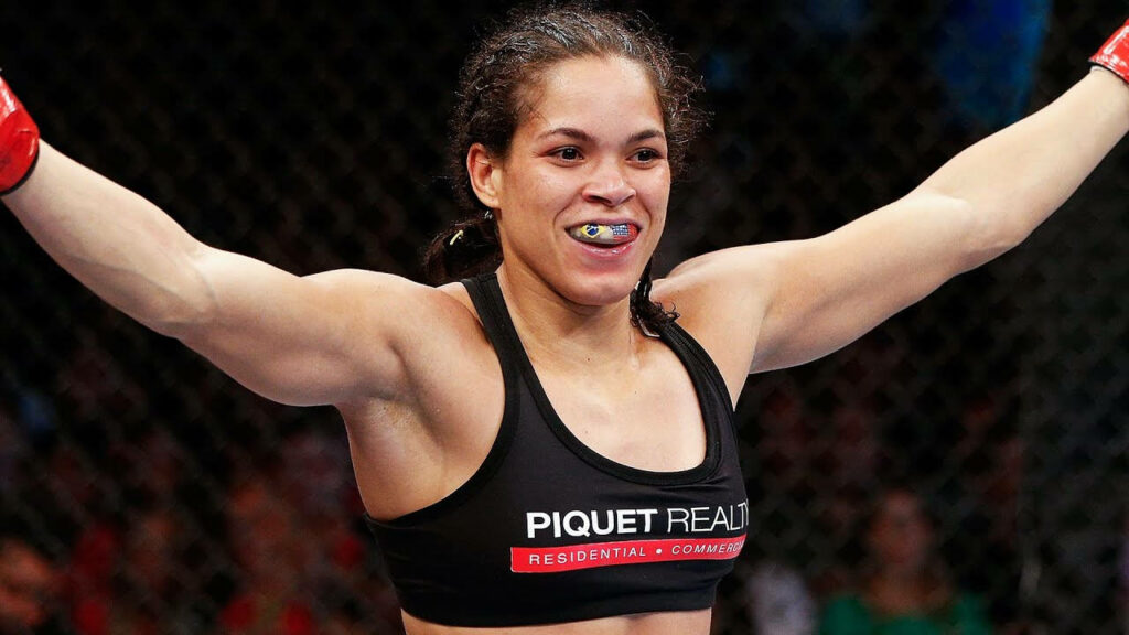 Amanda Nunes victorious inside octagon celebrating confident win MMA fight wallpaper background