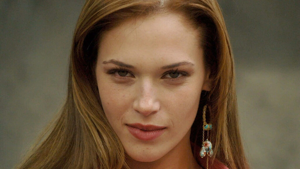 Close-up portrait of Amanda Righetti with intense gaze natural tones and soft lighting wallpaper background