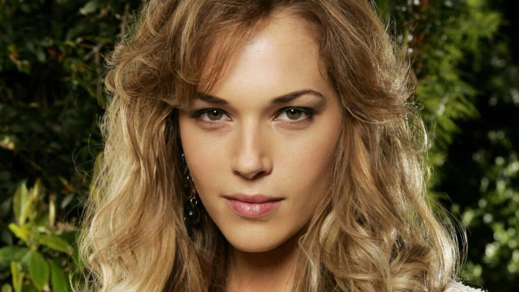 Close-up portrait of Amanda Righetti with soft natural light and lush green background wallpaper