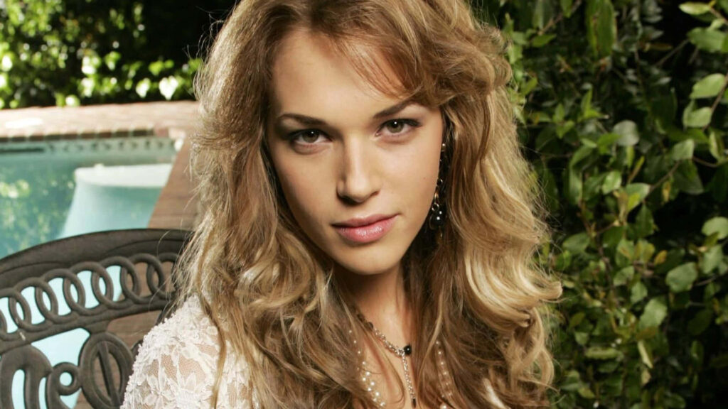 Amanda Righetti elegant poolside pose lush greenery glamorous sophisticated wallpaper background