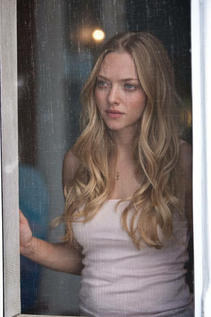 Amanda Seyfried thoughtful gaze out window scene from Dear John capturing quiet emotion reflection Wallpaper
