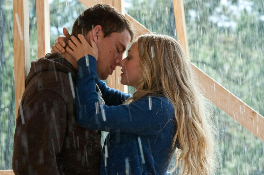 Amanda Seyfried and co-star share intimate romantic kiss in rain scene wallpaper background