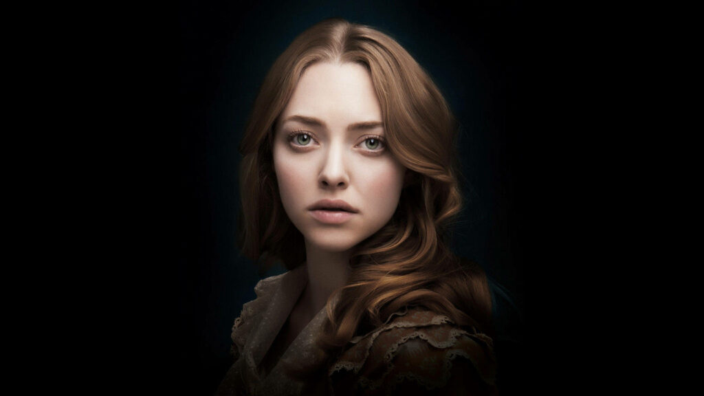 Amanda Seyfried as Cosette in Les Misérables dramatic portrait with dark background wallpaper