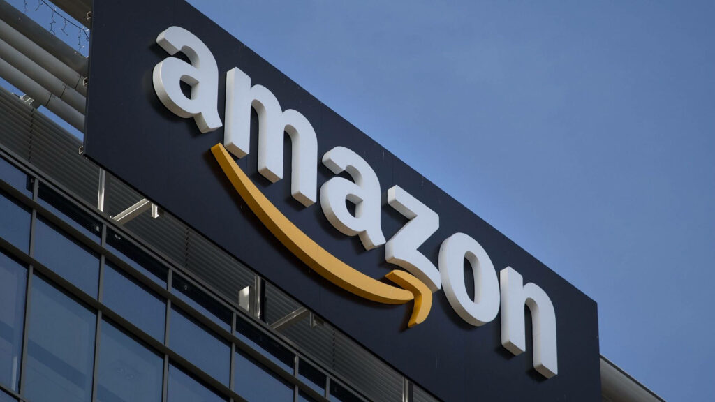 Amazon logo on modern office building exterior under clear blue sky wallpaper background