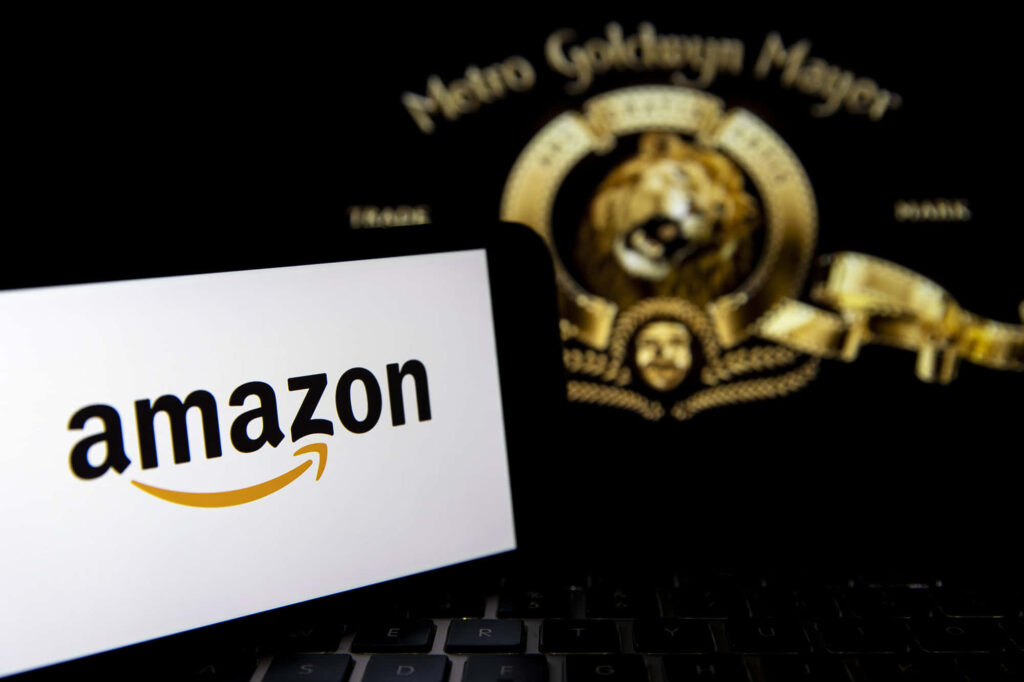 Amazon UK and MGM Studios collaboration wallpaper with Amazon logo and MGM lion emblem background