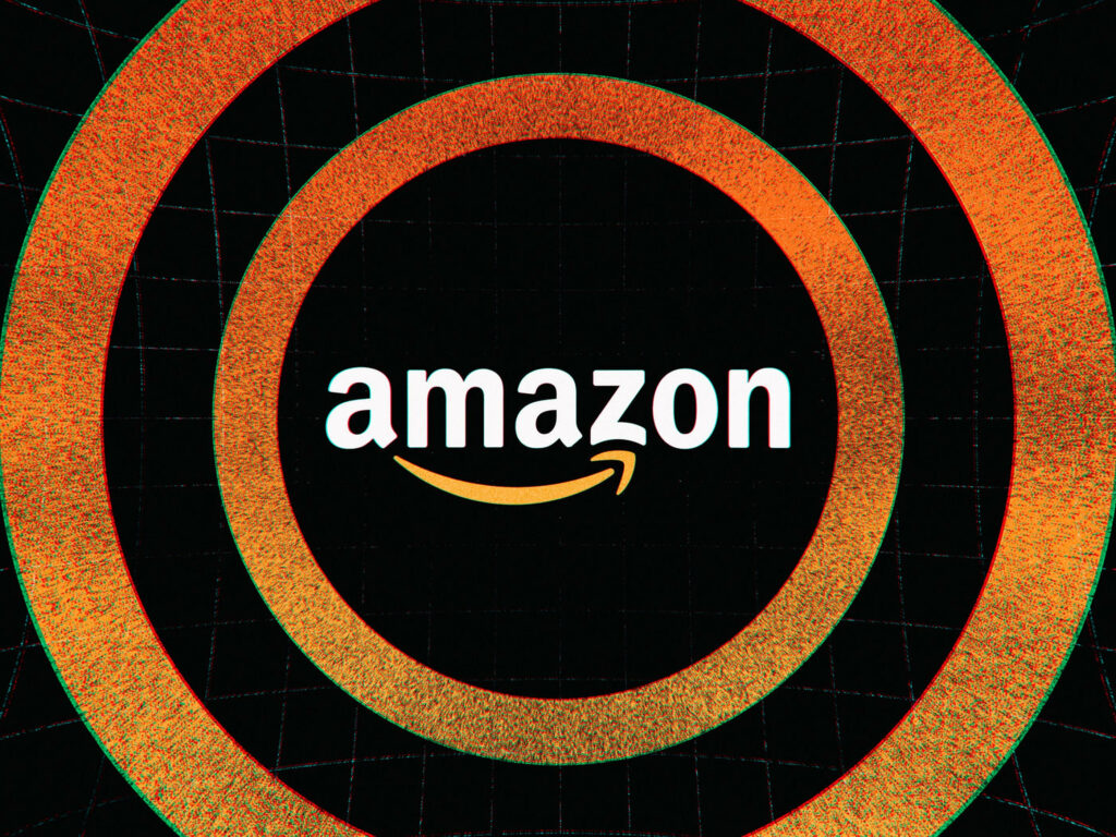 Amazonian Patterns: A Wallpaper Featuring Orange and Black Circular Designs with the Iconic Amazon Logo as the Focal Point