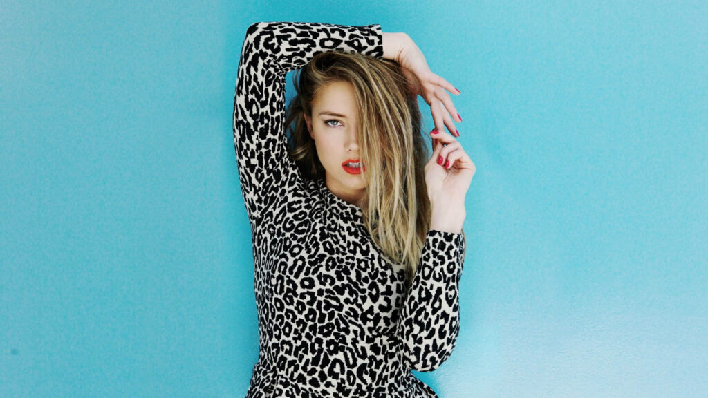 Amber Heard confident in chic leopard print outfit vibrant turquoise background Bullet Magazine wallpaper