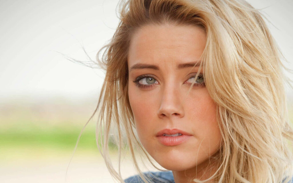 Amber Heard close-up portrait natural light elegant actress model and activist with wallpaper background