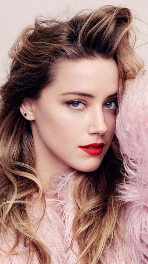 Amber Heard confident intense gaze bold red lips voluminous hair soft pink fur outfit wallpaper