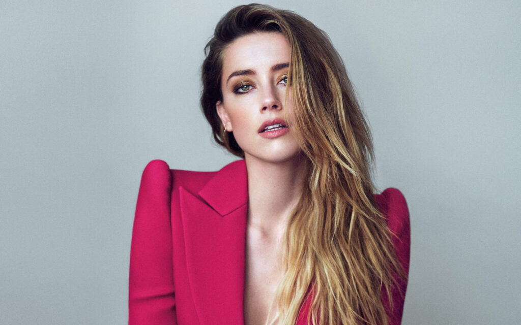 Amber Heard in bold red blazer posing confidently against minimalist background for Marie Claire wallpaper