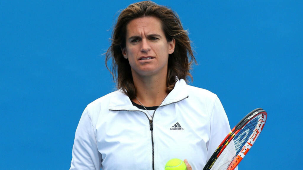 Amélie Mauresmo holding tennis racquet and ball in white Adidas jacket on blue background wallpaper